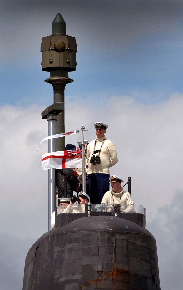 Crew of nuclear deterrent submarine HMS Vanguard on the conning tower as she departs Faslane