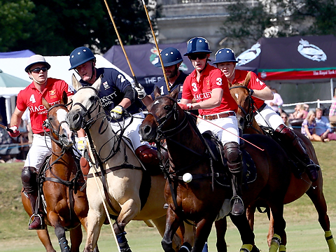 group competitors chasing polo ball as it bounces up