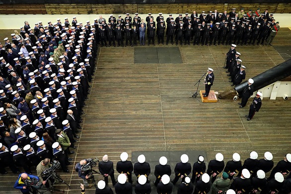 First Sea Lord addresses the ships company of HMS Albion in the well dock.