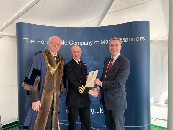 Commander Philip Harper is presented with his prestigious certificate. 